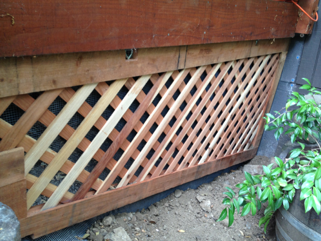 custom fabrication of panel by Wildlife Out technician keeping a family of skunks out from under a garage.
